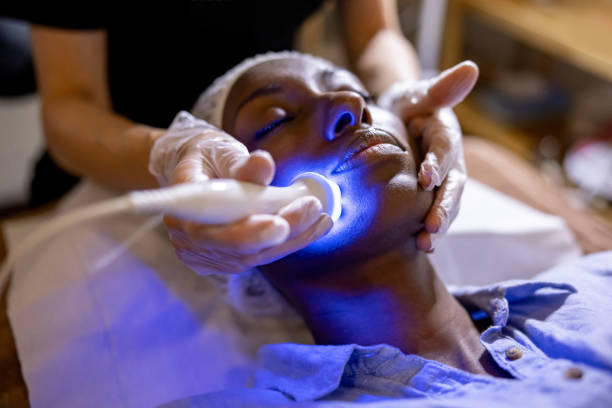 Professional skincare treatment with blue light therapy on a woman's face